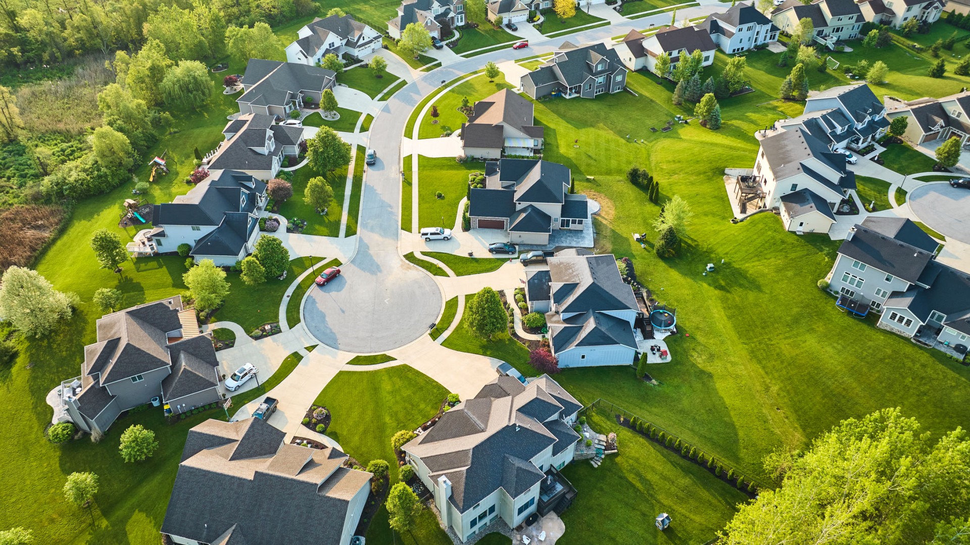 Aerial cul-de-sac of rich mini mansion homes in rich neighborhood